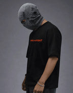 Black streetwear tee with orange 'BREAKPOINT' text, paired with textured gray balaclava, modern urban fashion