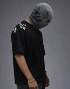 Black floral-embroidered streetwear tee with textured face mask, modern urban fashion