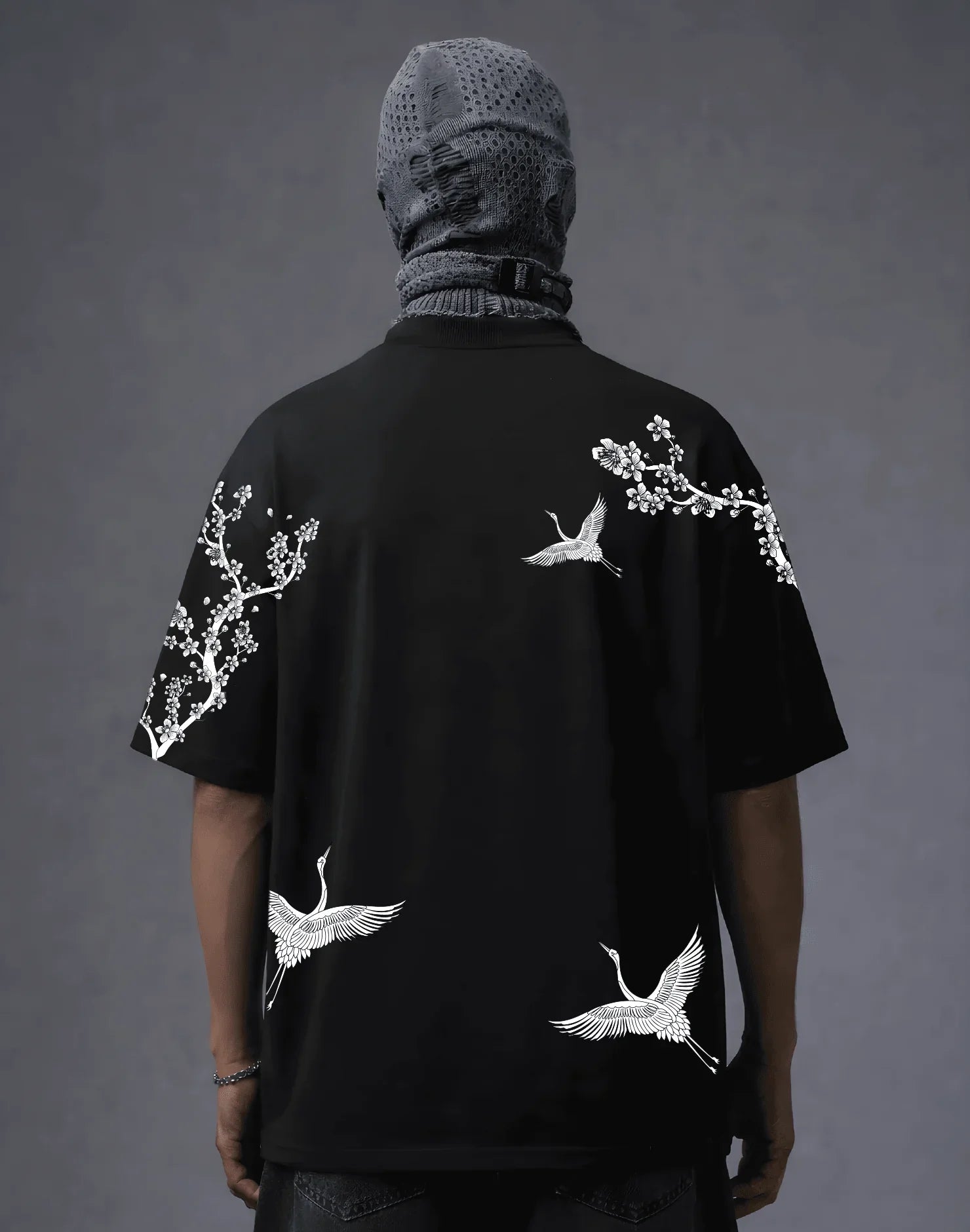 Black graphic tee with white crane and cherry blossom print, modern streetwear style